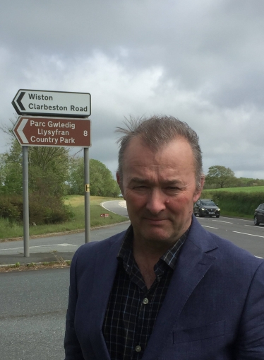 Simon Hart MP pictured at the Llysyfran Country Park sign on the A40 near Slebech.  The attraction has been closed since last year and will remain closed for some time to come.